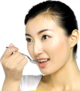 woman eating spoon